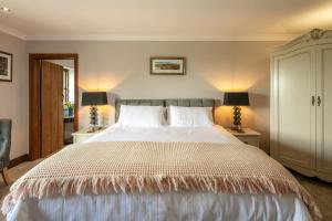 a bedroom with a large bed with two lamps at Beaconsview B&B in Brecon