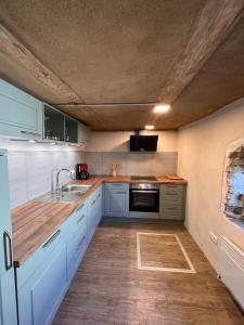 a kitchen with blue cabinets and a sink at Zierow Ostsee in Zierow