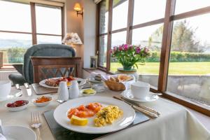 a table with a plate of breakfast food on it at Beaconsview B&B in Brecon