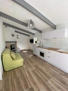 cocina grande con sofá amarillo en una habitación en Maison bord de lac de charmes, en Bannes