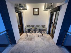 a room with two tables and chairs in a building at Vila Adelis in Vama Veche