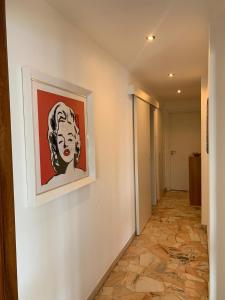 a painting of a woman on a wall in a hallway at La terrazza sul Golfo in Portovenere