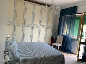 a bedroom with a bed and a chandelier at La terrazza sul Golfo in Portovenere