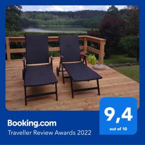 a pair of chairs sitting on a deck at RELAXX Home in Woryty