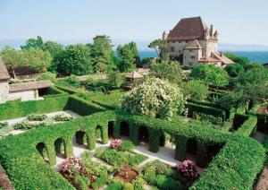 an aerial view of a garden with a building in the background at Le Petit Atelier in Excénevex