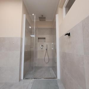 a shower with a glass door in a bathroom at Villa Dorina in Kaštel