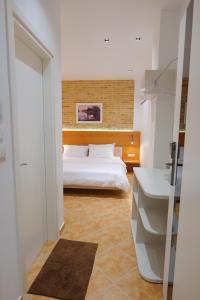 Postel nebo postele na pokoji v ubytování Hotel Piccolino