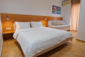 Postel nebo postele na pokoji v ubytování Hotel Piccolino