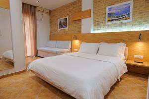 Postel nebo postele na pokoji v ubytování Hotel Piccolino