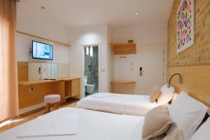 Postel nebo postele na pokoji v ubytování Hotel Piccolino