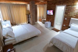 Postel nebo postele na pokoji v ubytování Hotel Piccolino