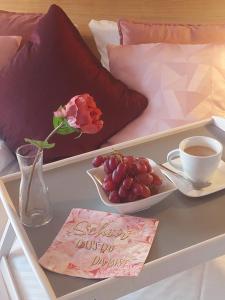 a table with a plate of grapes and a cup of coffee at Paleo Finest Serviced Apartments in Munich