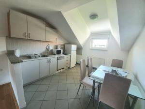 a kitchen with a table and chairs and a dining room at Apartment Lily near Zagreb airport in Velika Gorica