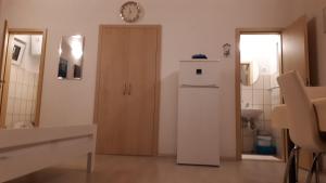 a room with a refrigerator and a clock on the wall at Apartment Gogi in Vodice +29 photos