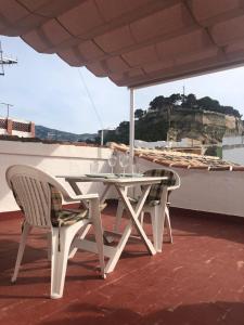 a table and chairs sitting on the roof of a boat at Casa Quimeres in Denia