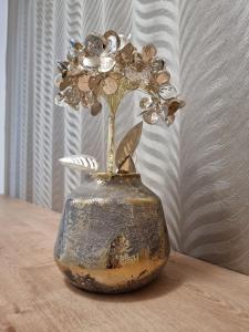 a vase with a flower in it on a table at BIVIO apartment Dolná in Banská Štiavnica