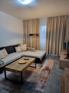 a living room with a couch and a coffee table at BIVIO apartment Dolná in Banská Štiavnica