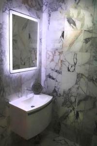 a bathroom with a white sink and a mirror at Luxury Spalato Garden in Split