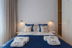 Łóżko lub łóżka w pokoju w obiekcie Mi Casa Holidays Apartamenty Olimpijska O2