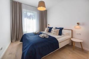 Łóżko lub łóżka w pokoju w obiekcie Mi Casa Holidays Apartamenty Olimpijska O2