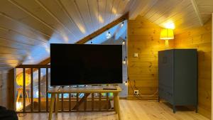 a flat screen tv sitting on a table in a room at Penthouse by the ski lift, 4 bedrooms, 2 living rooms in Stranda
