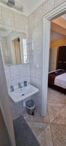 a bathroom with a sink and a mirror and a bed at Joy Guesthouse in Siófok +75 photos