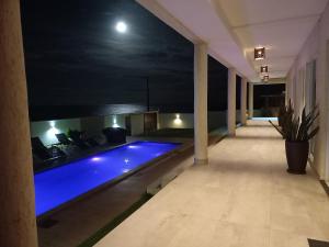 a swimming pool in a building at night at Vilamar in Tibau do Sul +19 photos