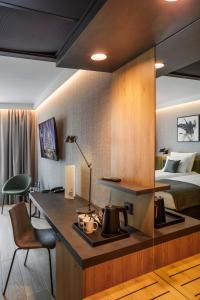 a hotel room with a desk and a bed at Q Hotel Plus Wrocław Bielany in Wrocław