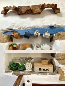 a shelf in a toy kitchen with items on it at RIBEIRA SACRA La Imperfecta in Ferreira de Panton +12 photos