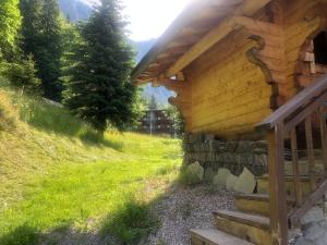 a log cabin with stairs to the side of it at Chalet Dufour in Morzine