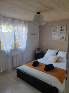 a bedroom with a large bed with two towels on it at Belle Océane in Lège