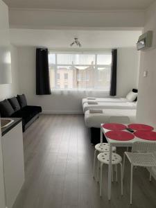 a living room with a bed and a table and chairs at Comfortable - Cosy - Budget Studios in City Center in London
