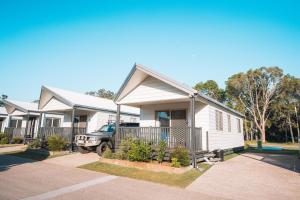 a house with a truck parked in front of it at BIG4 Breeze Holiday Parks - Rainbow Beach in Rainbow Beach