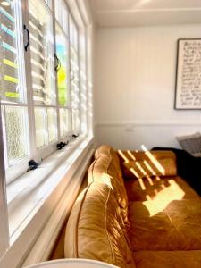 un sofá en una habitación con ventana en Urban Getaway Apartment Ipswich en Ipswich