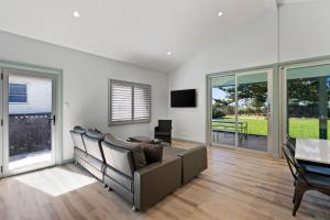 a living room with a couch and a table at Shelly Beach Holiday Home in Shelly Beach