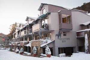 a building with a horse on the side in the snow at Squatters Run 12a in Thredbo