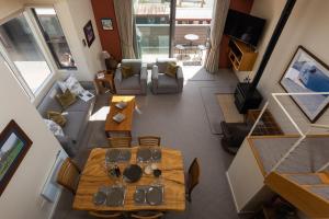 an overhead view of a living room with tables and chairs at Squatters Run 12a in Thredbo