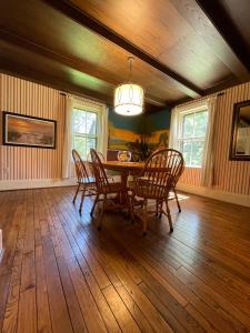 a dining room with a table and chairs at Avonlea Forest Hill Cottages in New Glasgow