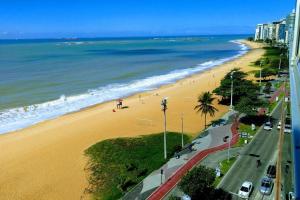 a view of a beach and the ocean at Cristal Residence in Vila Velha