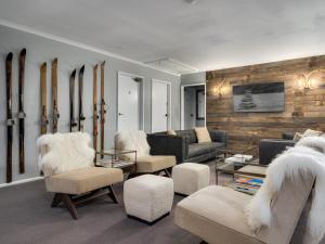 a living room with a couch and chairs and a table at Chalet Alpina in Jindabyne