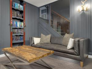 a living room with a couch and a coffee table at Chalet Alpina in Jindabyne