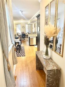 a living room with a vase of flowers on a table at COZY DOWNTOWN APARTMENT-Naval Academy Vicinity in Annapolis