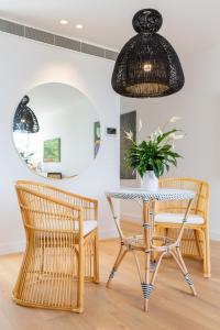 a dining room with a table and two chairs and a potted plant at Designer Luxury for 2 in Mornington