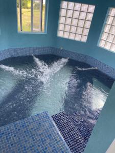 a large swimming pool with water in a room at ‘MORIAH’ Private Room with Double Bed and shared bathroom in Saint Philip