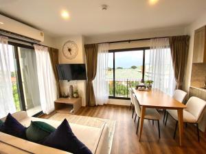 a living room with a table and a dining room at La Habana Hua Hin 2 Bedroom Seaview in Hua Hin