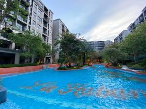 a large swimming pool in a city with buildings at La Habana Hua Hin 2 Bedroom Seaview in Hua Hin