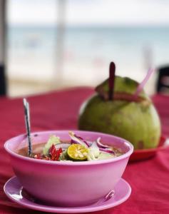 a bowl of soup on a table with a bowl of food at PD Best Homestay in Port Dickson