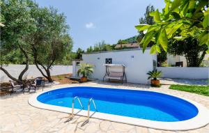 a swimming pool in the backyard of a house at Nice Home In Broce With House A Panoramic View in Broce