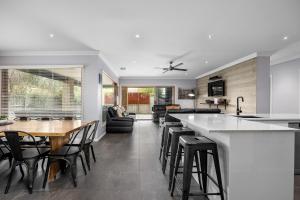 a kitchen and living room with a table and chairs at Luxury Coastal Escape in Tootgarook