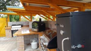a outdoor kitchen with a stove and an oven at The River Lodge in Ohakune